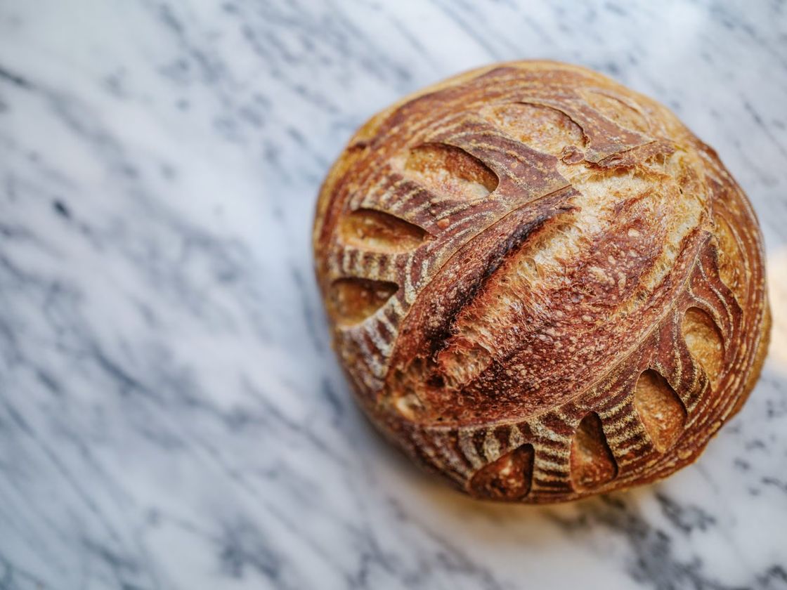 A scored sourdough loaf from Rahoma Grains